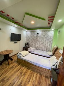 a bedroom with a bed and a flat screen tv at Hotel Best Ocean in Kathmandu