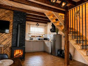 a kitchen with a stove in a room at Domek Pod-Górski in Baligród