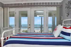 a bedroom with a bed with a view of the ocean at White Pelican by Pristine Property Vacation Rentals in Indian Pass