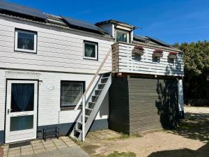 a house with a staircase on the side of it at La Casetta in Malden