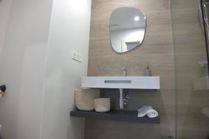 a bathroom with a sink and a mirror at IG Apartamentos in Palas de Rei +22 photos