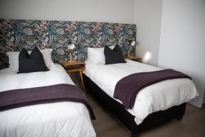 two beds sitting next to each other in a bedroom at PenthouseOne on the Canals in Marina Glades