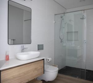 a bathroom with a sink and a glass shower at PenthouseOne on the Canals in Marina Glades +7 photos