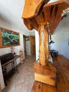 a wooden spiral staircase in a room with a table at Guest House Plitvice Waterfall in Plitvička Jezera