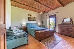 a bedroom with a bed and a dresser and a television at Il Querciolo - Azienda biologica, Agriturismo e Cantina in Marciano +114 photos