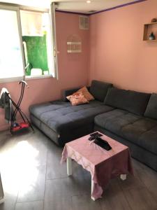 a living room with a couch and a table at Studio cosy in Orly