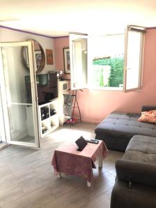 a living room with a couch and a table at Studio cosy in Orly