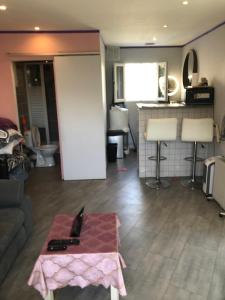 a living room with a couch and a table at Studio cosy in Orly