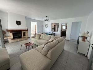 a living room with a couch and a table at Terredesel Oleron in Saint-Denis-dʼOléron