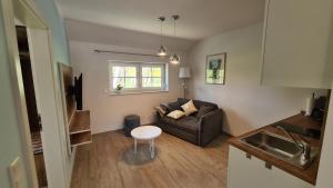 a living room with a couch and a table at Stara Broznja in Burg
