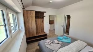 a bedroom with a bed with two towels on it at Stara Broznja in Burg