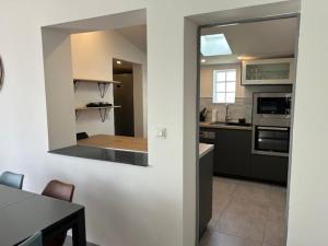 a kitchen with a counter top and a table in a room at Terredesel Oleron in Saint-Denis-dʼOléron