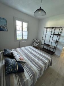 a bedroom with a large bed and a chair at Terredesel Oleron in Saint-Denis-dʼOléron +21 photos