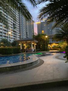 a courtyard with a gazebo and palm trees and buildings at Verdon Parc Butterfly Haven in Davao City