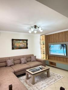 a living room with a couch and a table at luxury studio's J&M in Sarandë