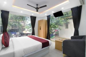 a bedroom with a bed and a window and a couch at Hotel Royal City Palace in Kolkata