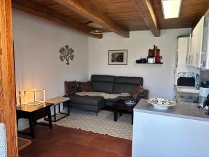a living room with a couch and a table at Fachwerkhaus in Ahrenshoop +17 photos