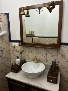 a bathroom with a sink and a mirror at Casa Las Adelfas in Isla Cristina +19 photos