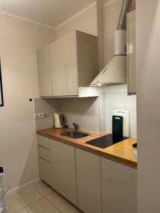 a kitchen with white cabinets and a sink at K14 Stay 1 in Riga