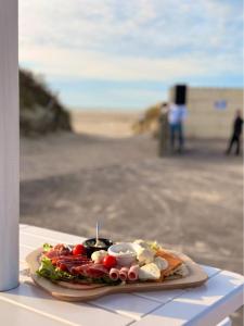 a plate of food on a table near the beach at Camping de la Mer in Camiers +34 photos