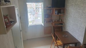 a dining room with a table and a window at appartement 4 places centre-ville in Cauterets