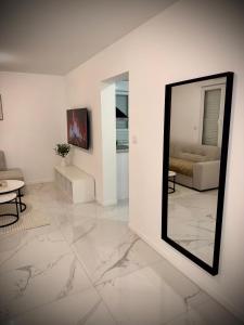 a living room with a mirror and a couch at Casa Bianca - Maison à Orléans in Orléans