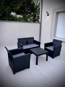 a patio with two chairs and a table and a bench at Casa Bianca - Maison à Orléans in Orléans