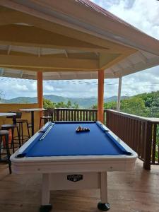 a pool table on the deck of a house at Eden Crest Villa in Anse La Raye