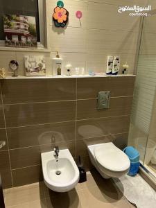a bathroom with a toilet and a sink at Jordan Amman in Amman +18 photos