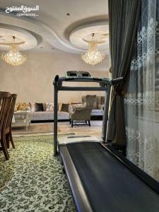 a room with a treadmill in a living room at Jordan Amman in Amman