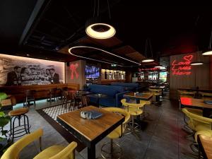 a restaurant with tables and chairs and a bar at Hotel 219 Budva in Budva