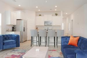 a living room with a blue couch and a kitchen at Backwater Bliss by Pristine Properties Vacation Rentals in Saint Joe Beach