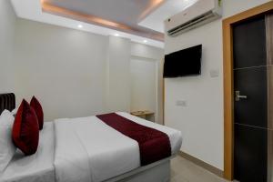 a bedroom with a bed and a flat screen tv at Hotel Royal City Palace in Kolkata
