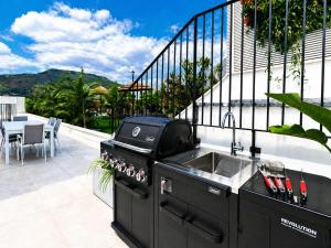 a kitchen with a sink and a grill on a patio at Sea 300 Villa in Migdal