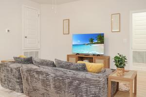 a living room with a couch and a flat screen tv at Backwater Bliss by Pristine Properties Vacation Rentals in Saint Joe Beach