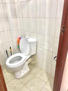 a bathroom with a white toilet in a stall at Kin Bnb in Ruaka +2 photos