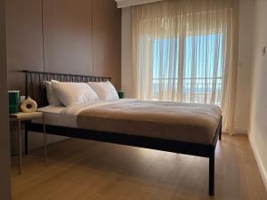 a bedroom with a large bed with a window at Marea Apartment in Bar