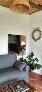 a living room with a couch and a ceiling fan at A Toca, Complete townhouse apartment in Monchique