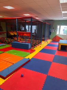 a room with colorful floors and a game room at Camping de la Mer in Camiers