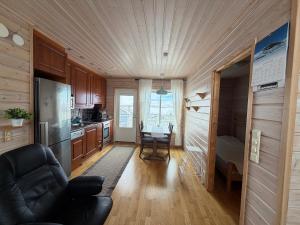 a kitchen with a couch and a table in a room at Kilpis-Silent Apartment in Kilpisjärvi