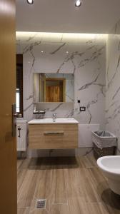 a bathroom with a sink and a mirror at Perla e Tomorrit EZ in Ujanik +83 photos