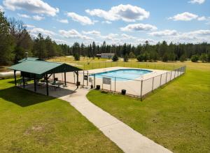 an overhead view of a swimming pool in a field at Emerald Escape in Grayling