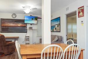 a dining room and living room with a table and chairs at Wales Pod by Pristine Properties Vacation Rentals in Indian Pass