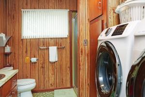 a bathroom with a toilet and a washing machine at Wales Pod by Pristine Properties Vacation Rentals in Indian Pass +41 photos