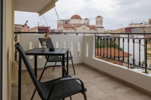 a balcony with a table and a view of the city at Lounetta Apartments 1 in Missolonghi