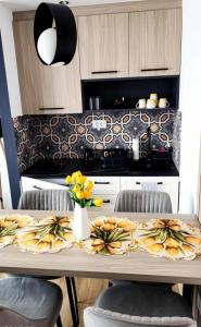a kitchen with a table with yellow flowers on it at Central luxury apartment ROOM 4 in Ohrid