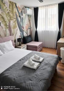 a bedroom with a bed with two towels on it at Central luxury apartment ROOM 4 in Ohrid