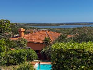 a view of a house with a swimming pool and trees at Villa Gilda - Private Pool by Host Hero in Stintino