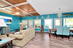 a living room with a couch and a table at Dolphin Daze by Pristine Properties Vacation Rentals in Saint Joe Beach