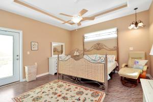 a bedroom with a crib and a ceiling fan at Dolphin Daze by Pristine Properties Vacation Rentals in Saint Joe Beach
